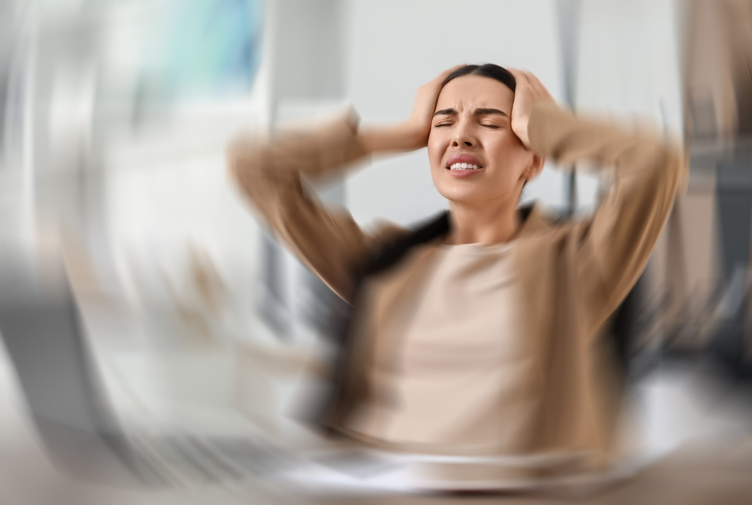 Woman,Suffering,From,Headache,Indoors,,Motion,Blur,Effect