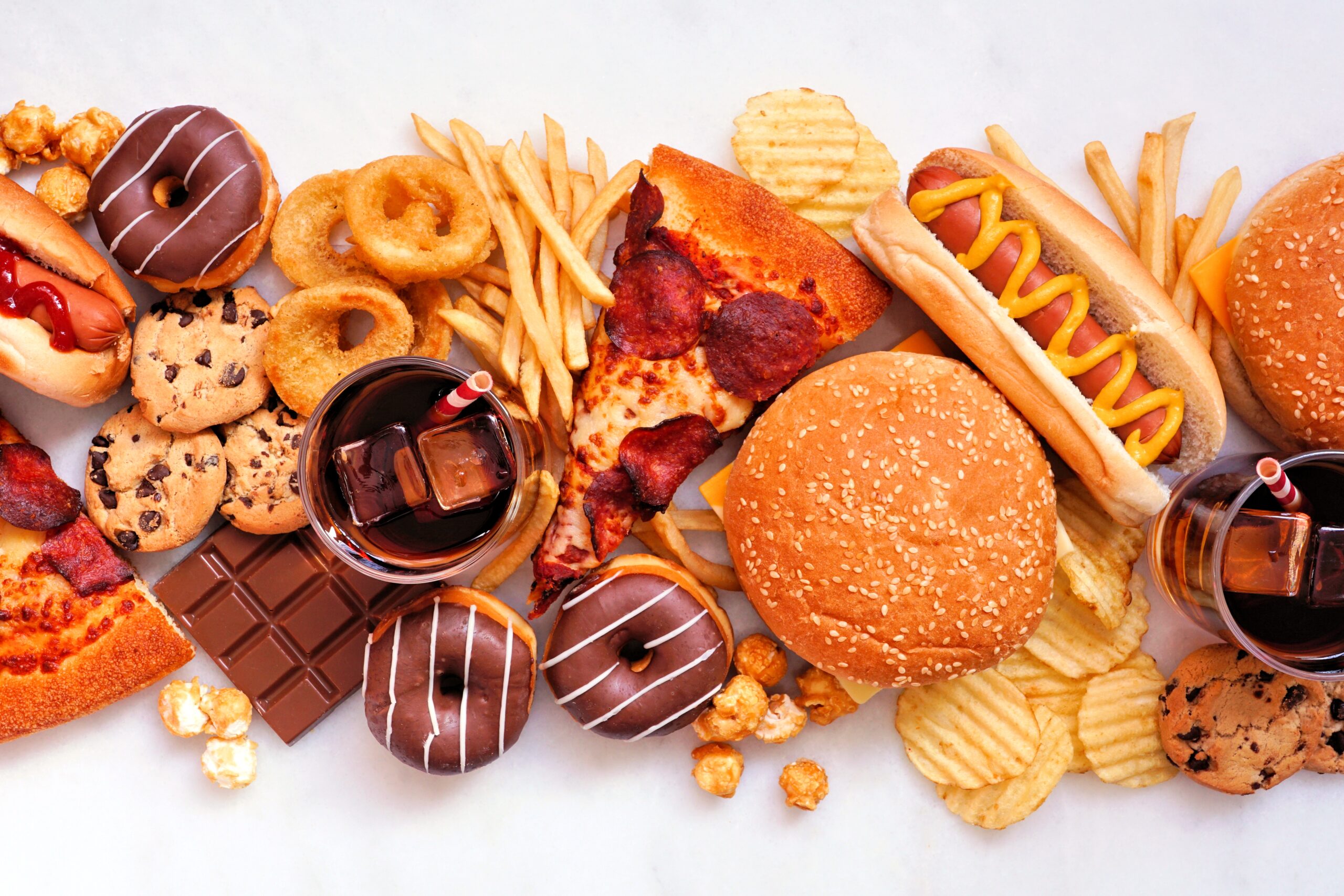 Junk,Food,Table,Scene,Scattered,Over,A,White,Marble,Background.